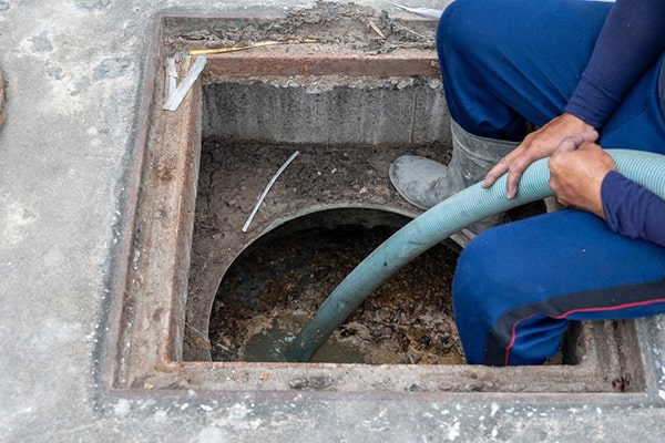 regularly scraping dishes before washing them and using enzyme-based drain cleaners can help reduce the need for frequent grease trap pumping